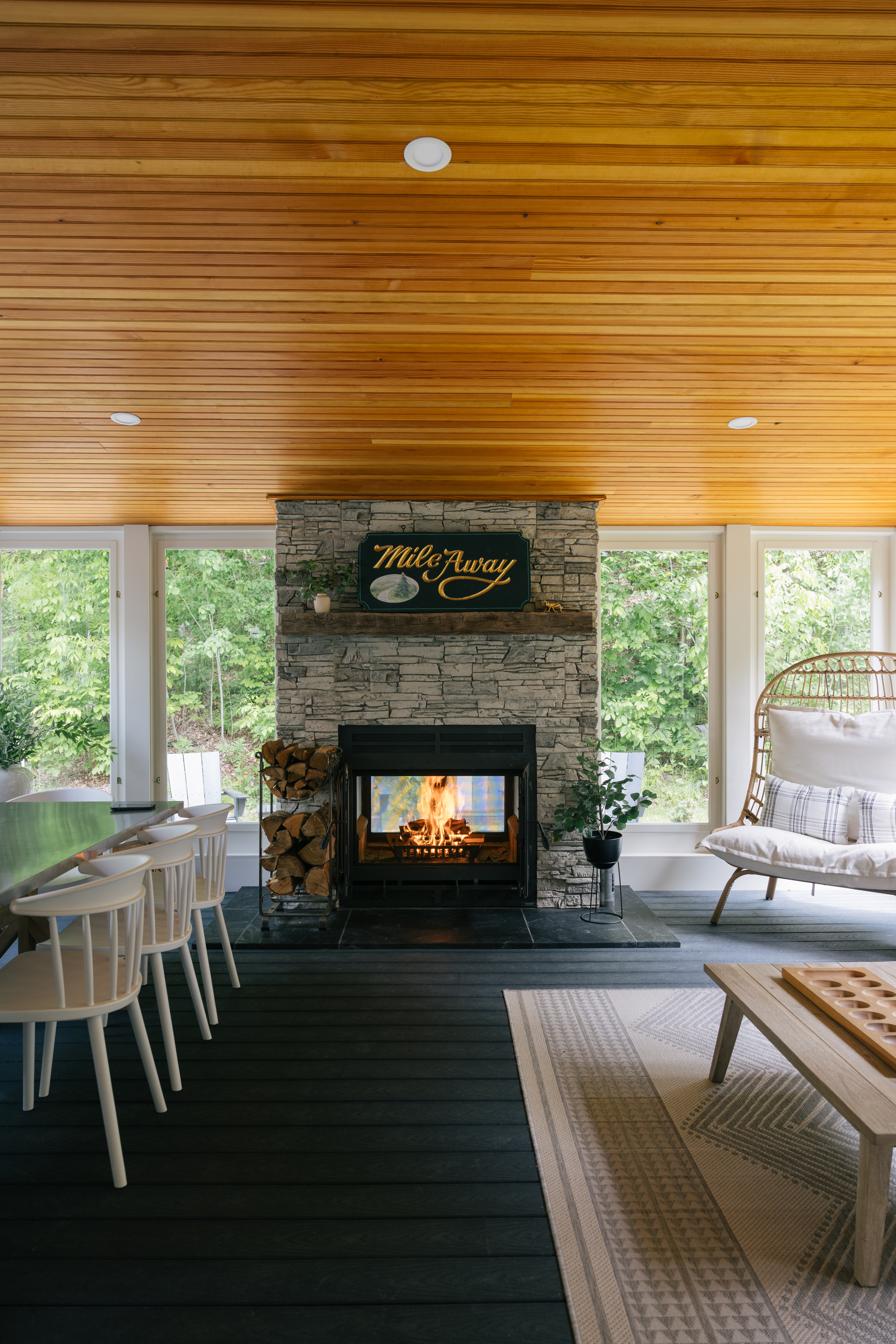Outdoor patio with seating and views of the surrounding trees and yard